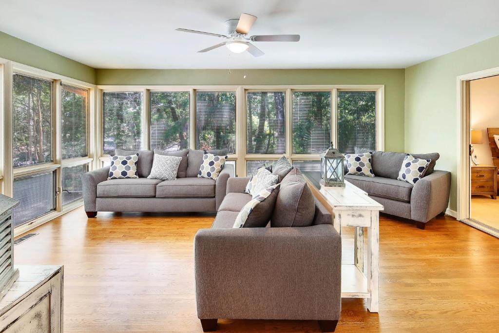 a living room with two couches and a ceiling fan at Baywood Luxury in Seabrook Island