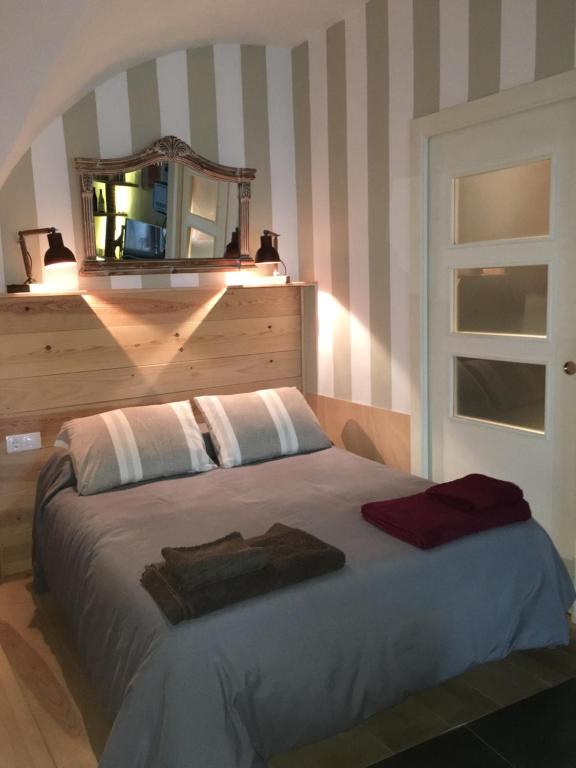 1 dormitorio con 1 cama con espejo en la pared en Santa Clara, en Cáceres