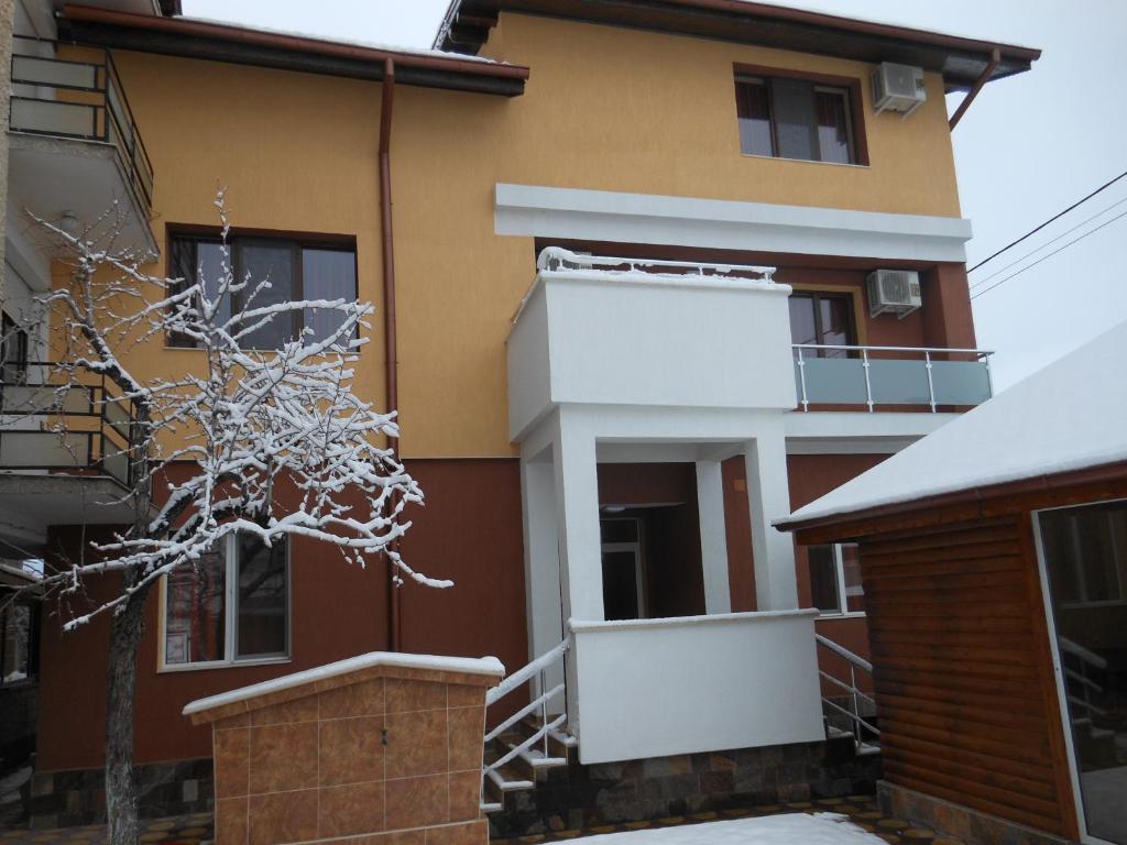 a house with snow on the outside of it at Guest House Goranovi in Velingrad