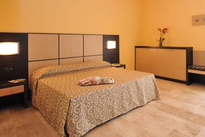 a bedroom with a bed with a tray on it at Ai Pigni De Cerù in Fumane