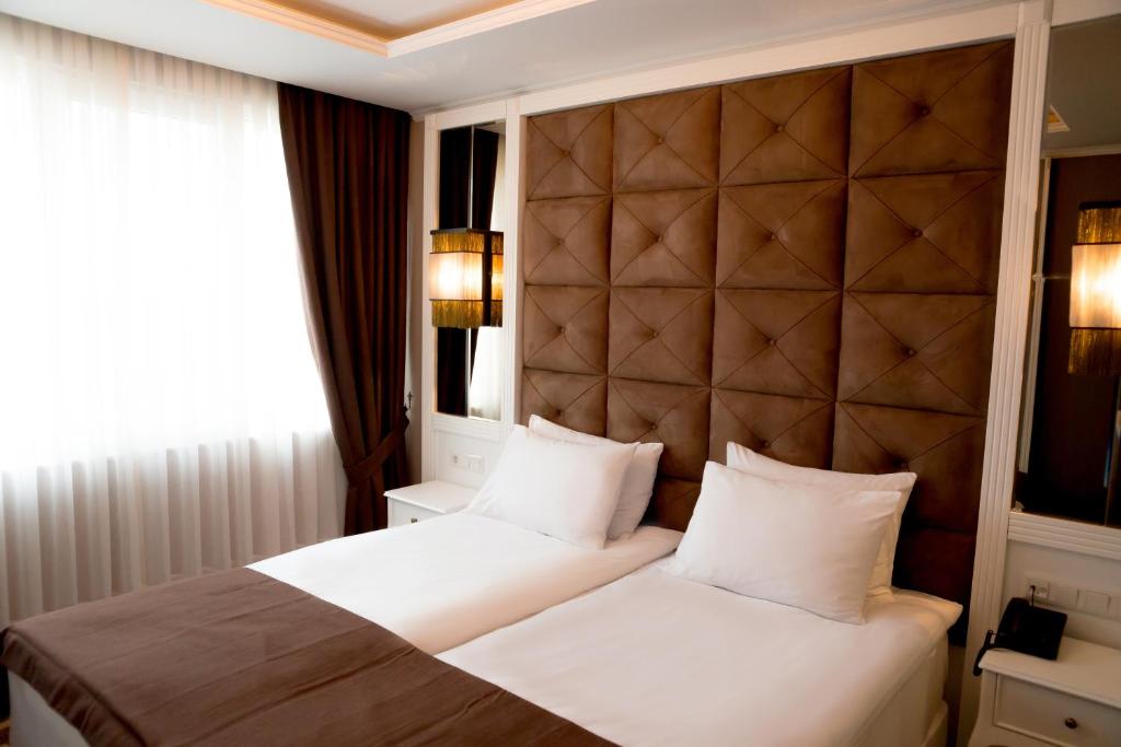 Postel nebo postele na pokoji v ubytování Hotel Arpezos