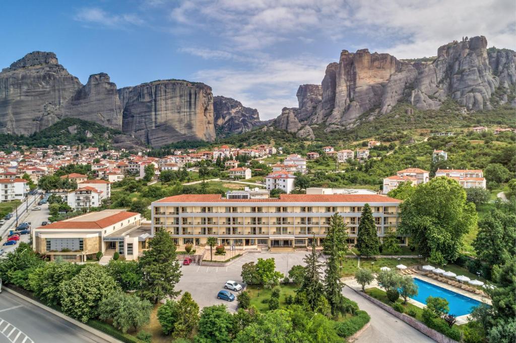 a view of a resort with mountains in the background at Divani Meteora Hotel in Kalabaka