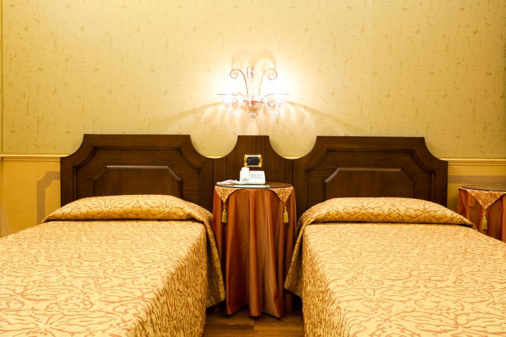 Postel nebo postele na pokoji v ubytování Hotel Al Codega