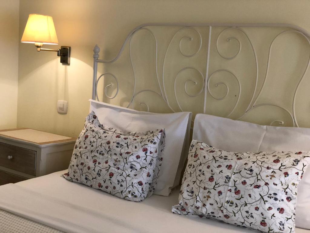 a bedroom with a bed with two pillows on it at Guest House Sea Breeze in Sveti Stefan