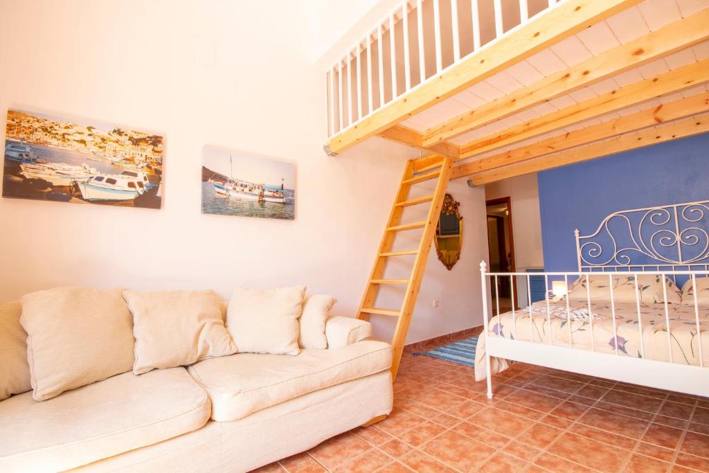 a living room with a couch and a bunk bed at Villa Galanis in Symi