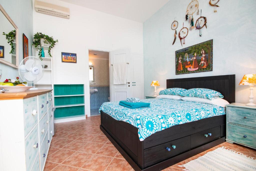 a small bedroom with a bed and a kitchen at Villa Galanis in Symi