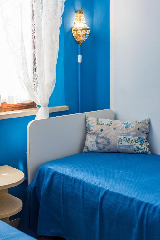 Postel nebo postele na pokoji v ubytování Hotel Stefania