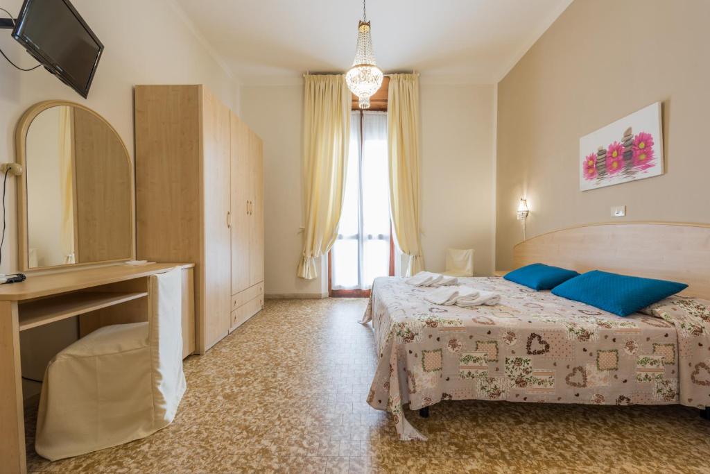 Postel nebo postele na pokoji v ubytování Hotel Stefania