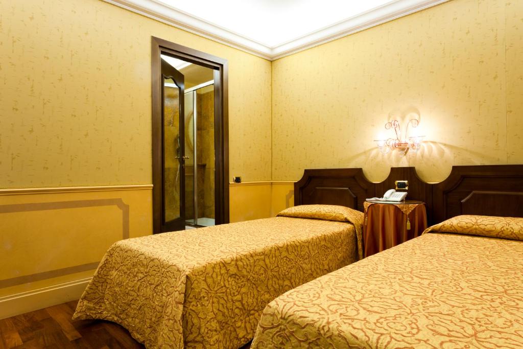 Postel nebo postele na pokoji v ubytování Hotel Al Codega