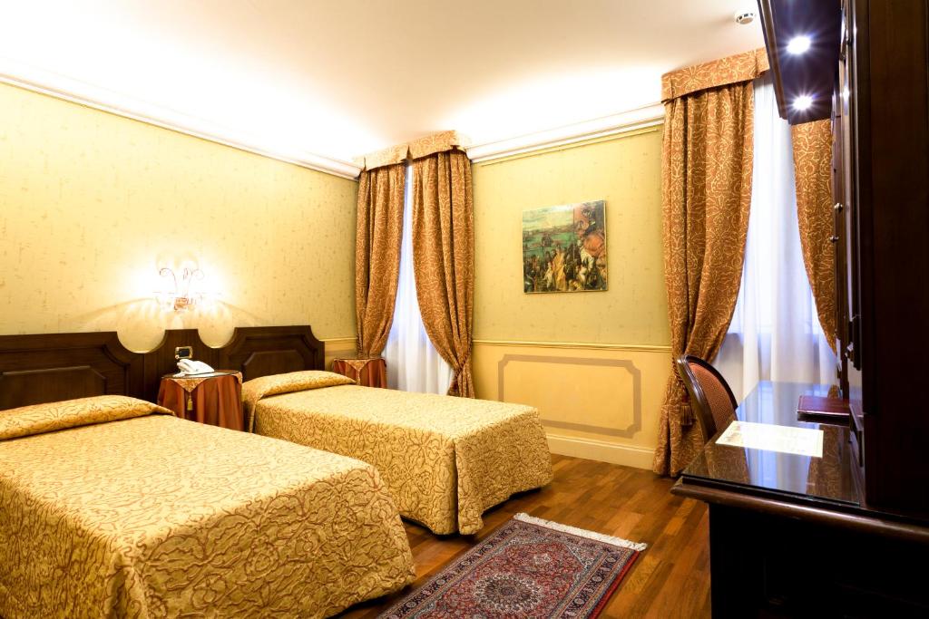 Postel nebo postele na pokoji v ubytování Hotel Al Codega