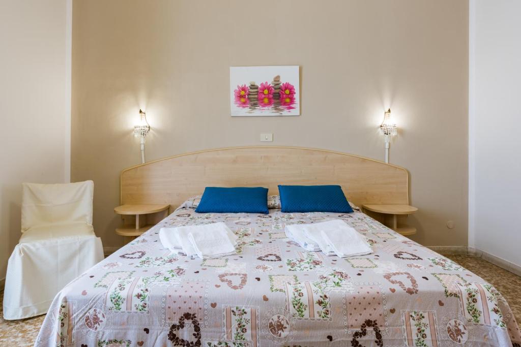 Postel nebo postele na pokoji v ubytování Hotel Stefania