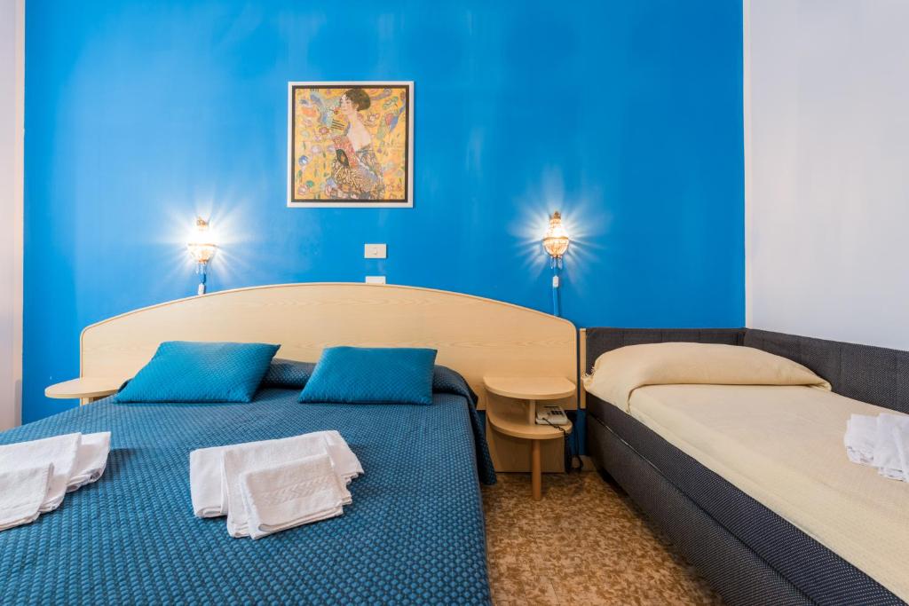 Postel nebo postele na pokoji v ubytování Hotel Stefania