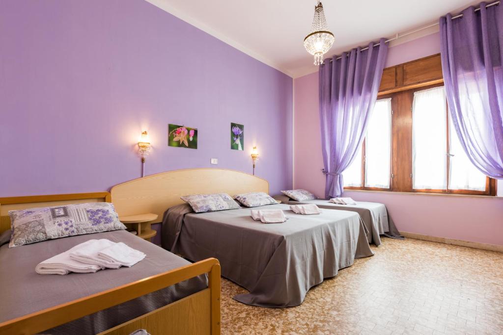 Postel nebo postele na pokoji v ubytování Hotel Stefania
