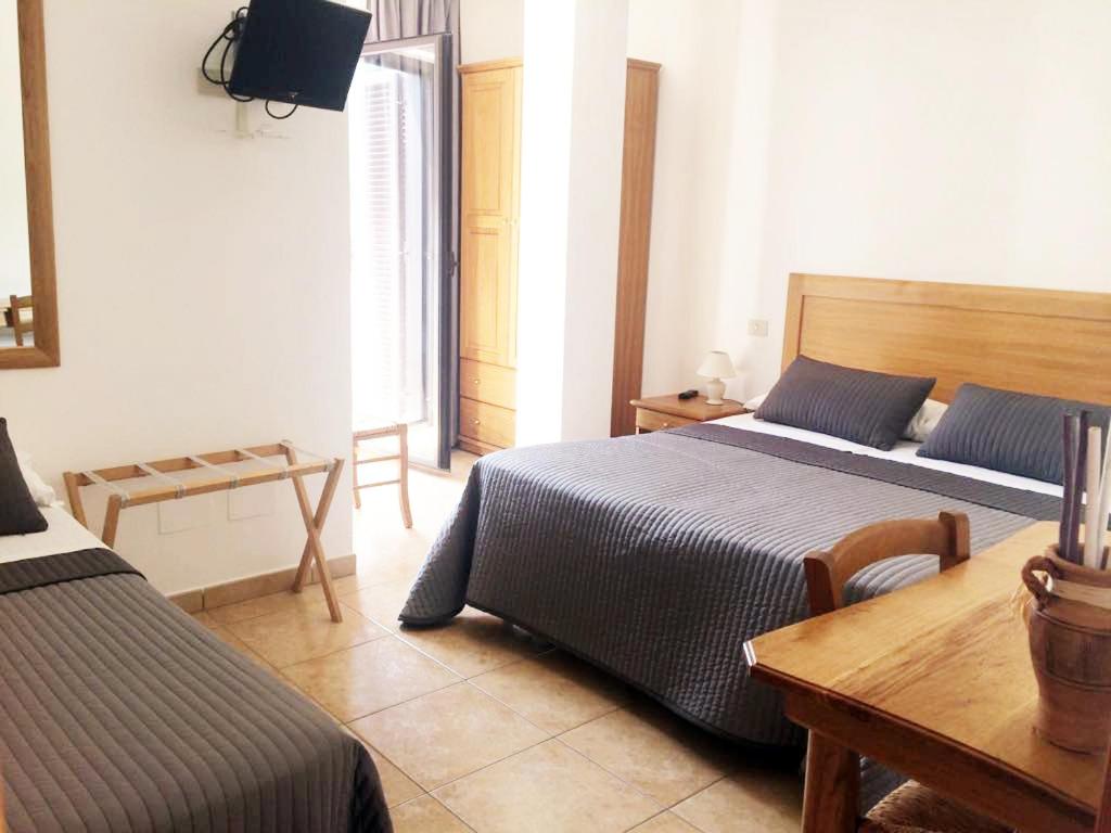 Postel nebo postele na pokoji v ubytování Albergo Villa Riccio