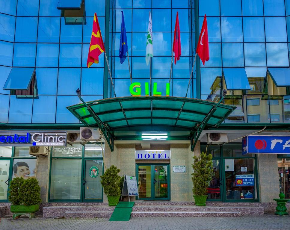 a hotel with flags on top of a building at Green Center Gili in Gostivar