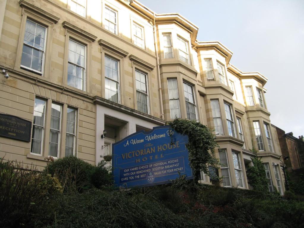 a large building with a sign on the side of it at Victorian House in Glasgow