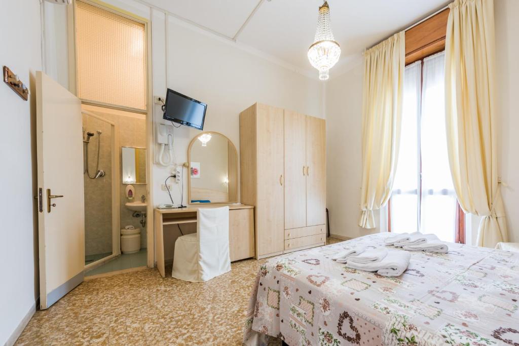 Postel nebo postele na pokoji v ubytování Hotel Stefania