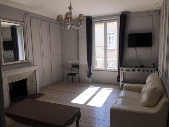 a living room with a couch and a fireplace at SAINT MALO Appartement in Saint Malo