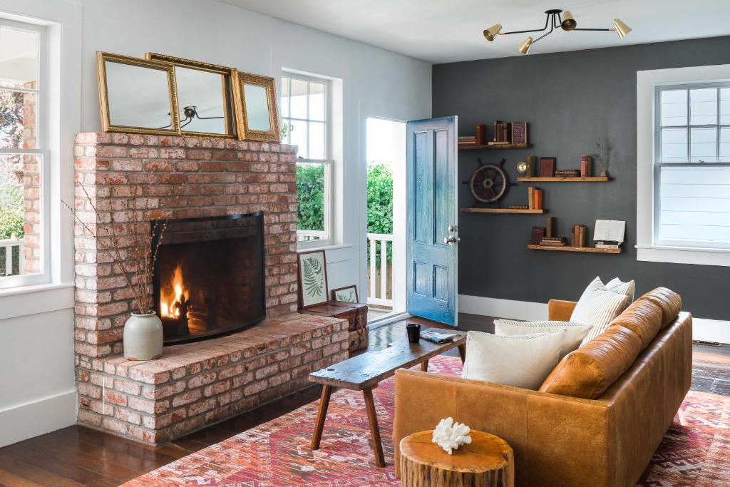 a living room with a couch and a fireplace at Inns of Mendocino in Mendocino