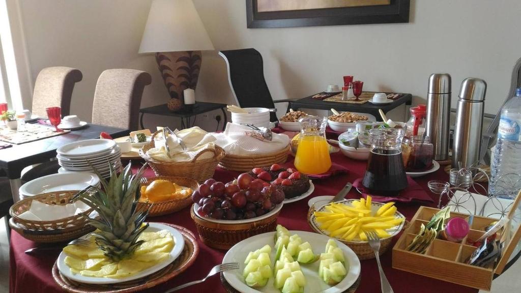 a table topped with plates of food and fruit at Residence Lagos in Lagos