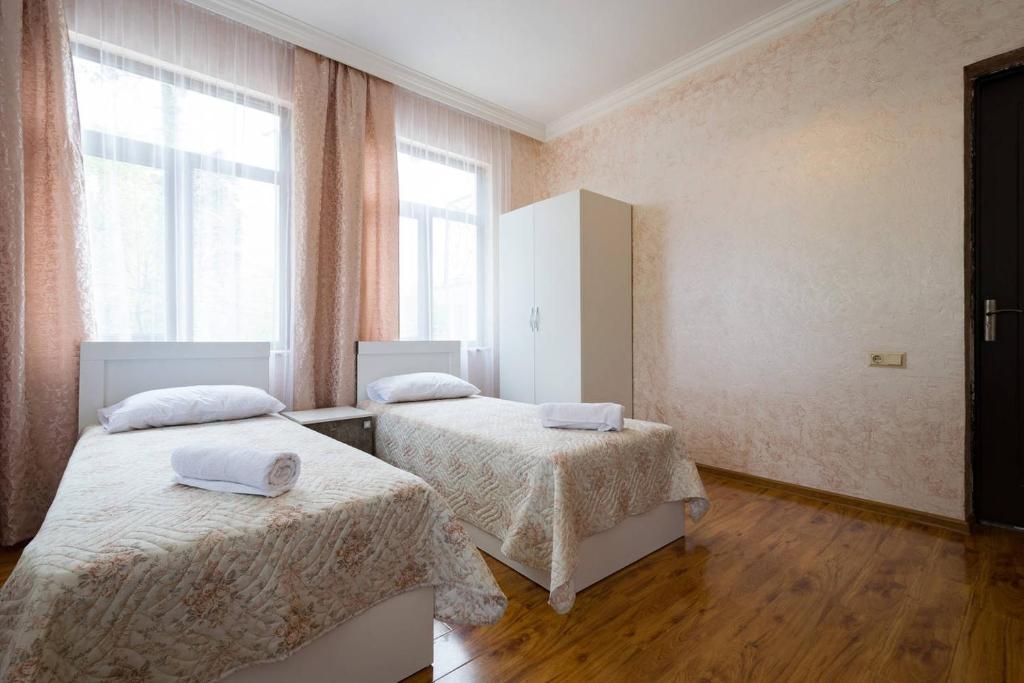 Un ou plusieurs lits dans un hébergement de l'établissement Sunny Hotel Batumi
