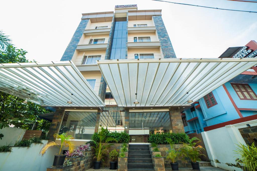 a building with awning and stairs in front of it at Spring Field Billets in Cochin