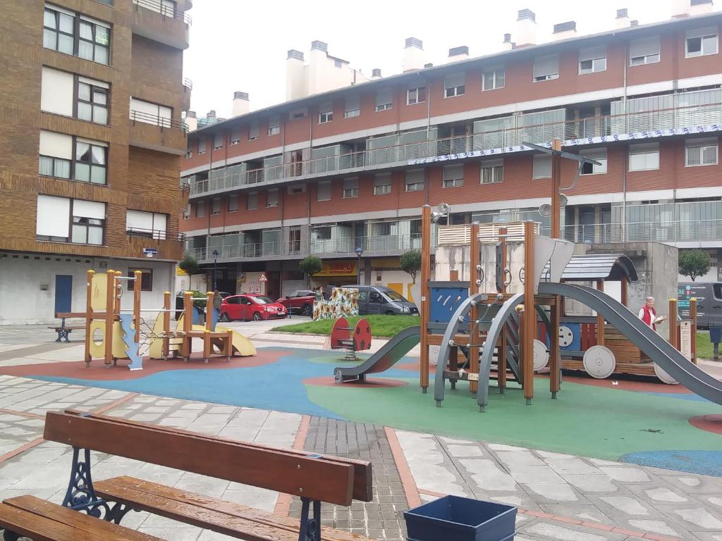 a playground with a slide in front of a building at Apartamento La Villa EBi 867 in Portugalete