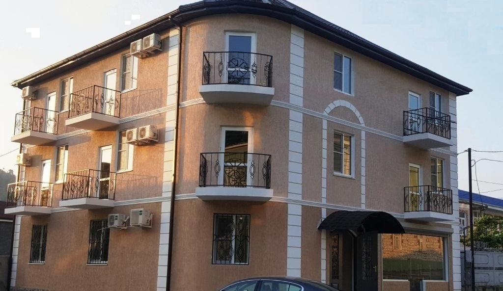 a large building with balconies on the side of it at Отель на Садовой in Sukhum