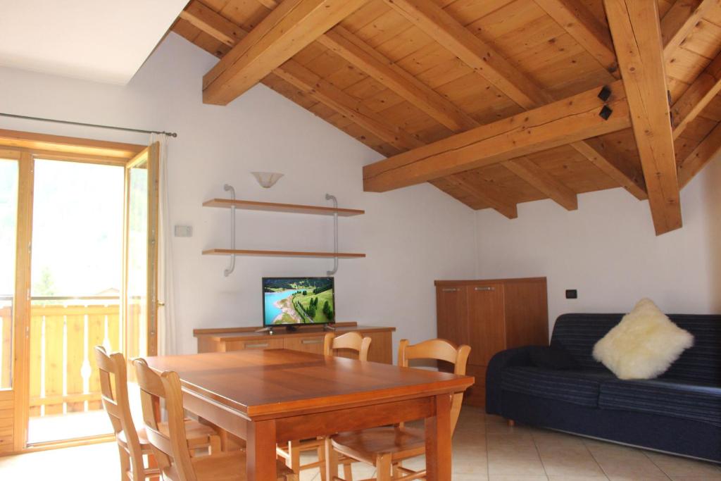 ein Wohnzimmer mit einem Holztisch und einem Sofa in der Unterkunft Mountain Home - Families Holidays in Valdidentro