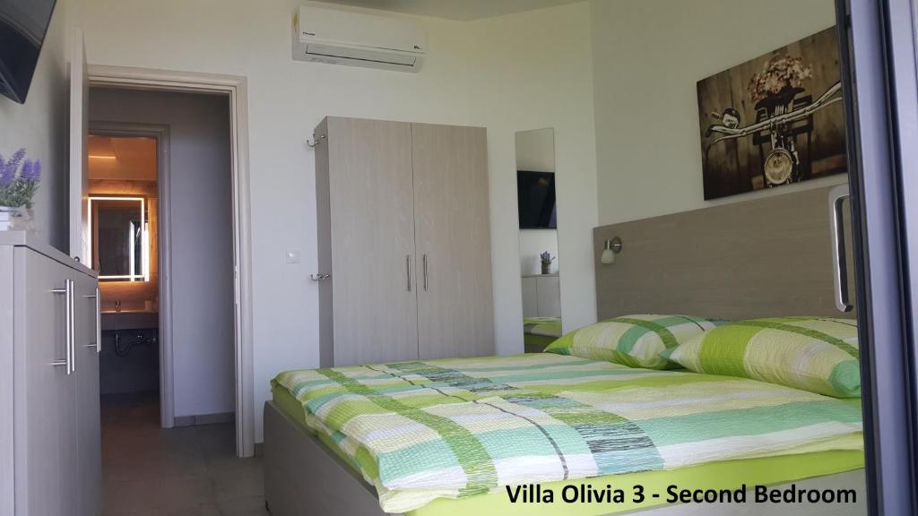 Postel nebo postele na pokoji v ubytování Villa Olivia