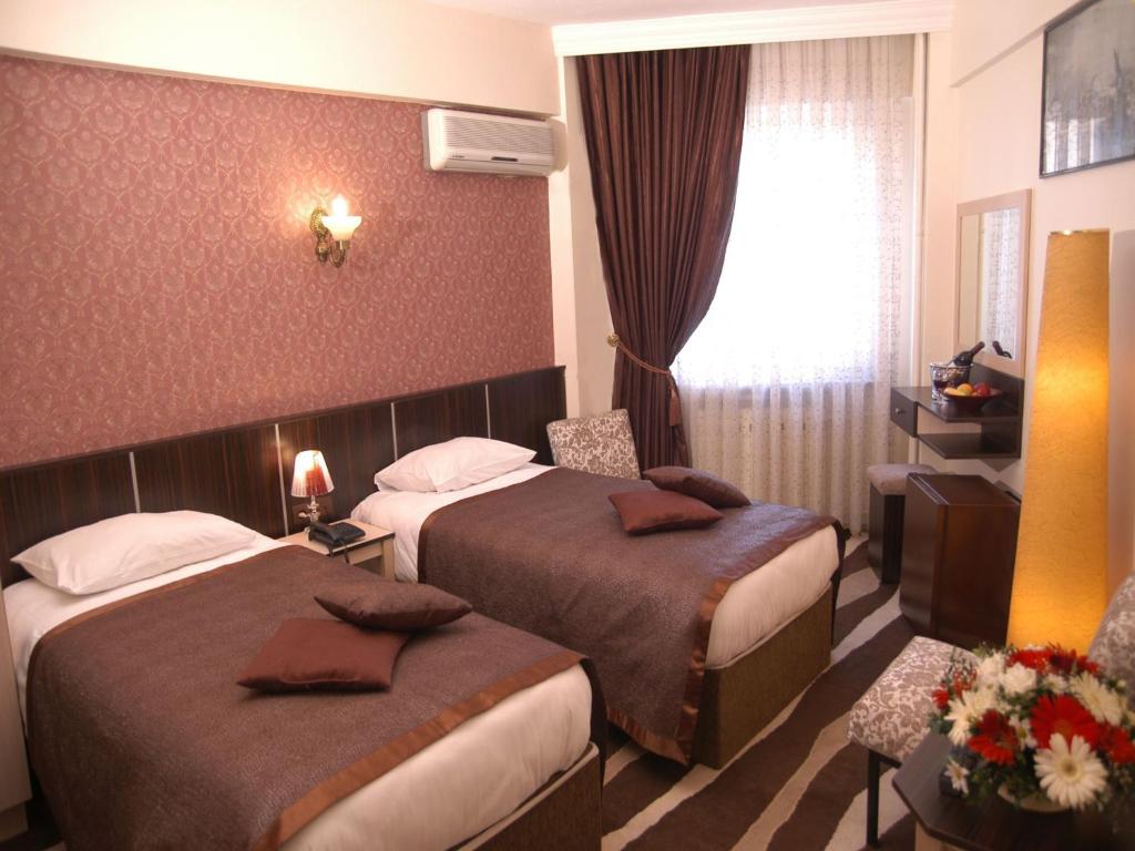 Cama o camas de una habitaci&oacute;n en Maya Hotel