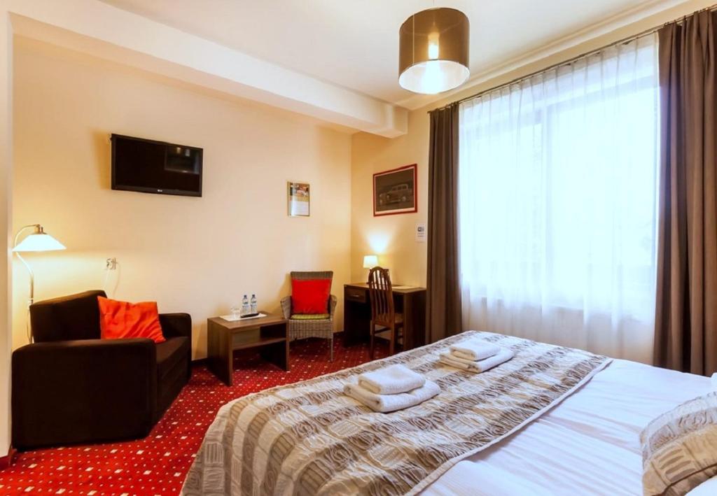 Łóżko lub łóżka w pokoju w obiekcie Hotel Kochanów