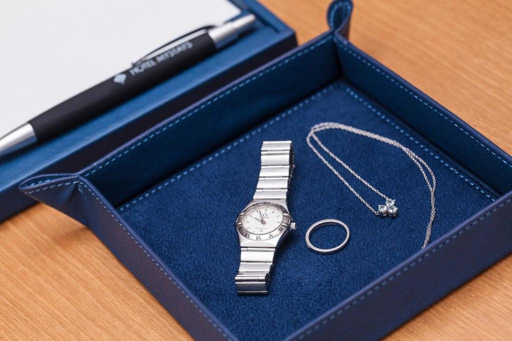 a silver watch in a blue box with a pen at Hotel Mystays Premier Akasaka in Tokyo