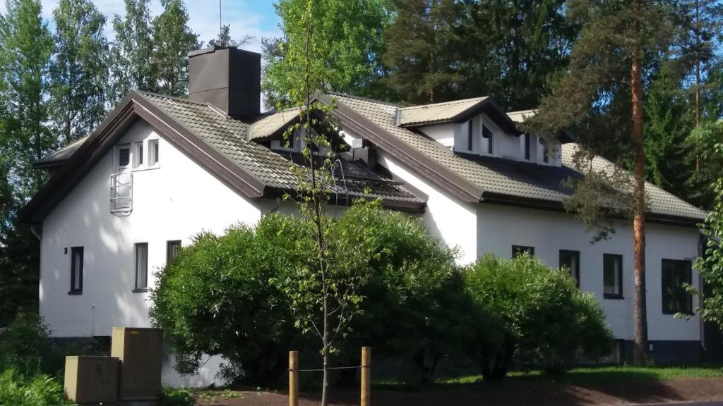 a white house with a black roof at Imatran Portti in Imatra