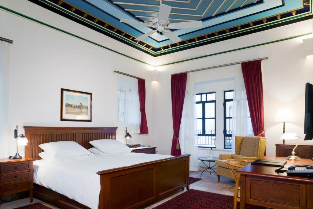 a bedroom with a bed and a coffered ceiling at The American Colony Hotel - Small Luxury Hotels of the World in Jerusalem