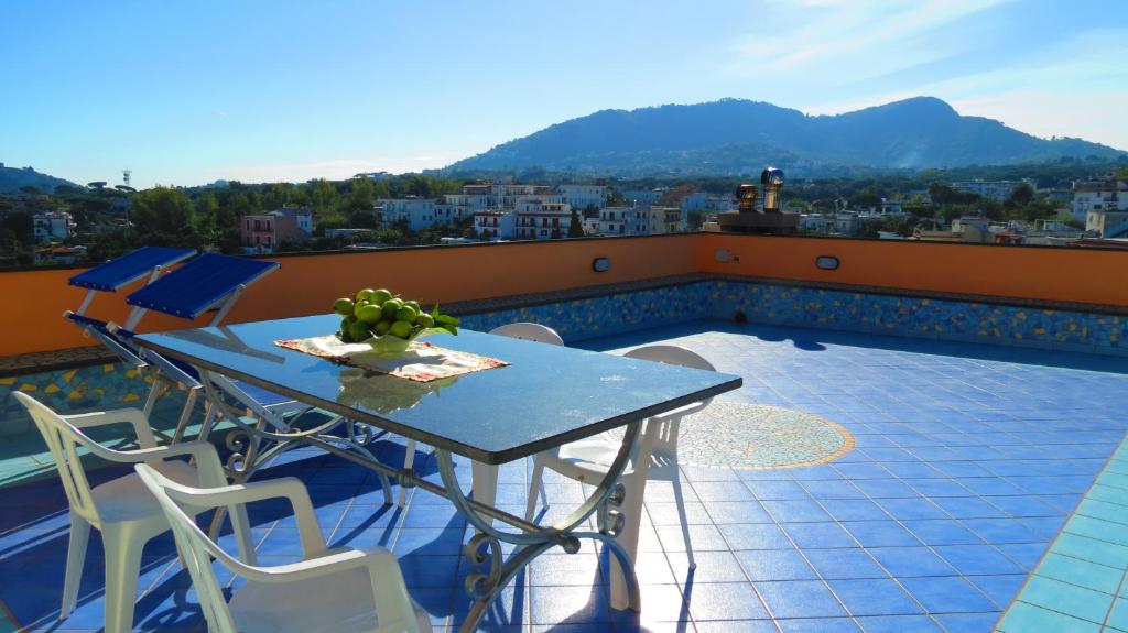 einen Tisch und Stühle auf einem Balkon mit Aussicht in der Unterkunft Villa Flora Ischia in Ischia