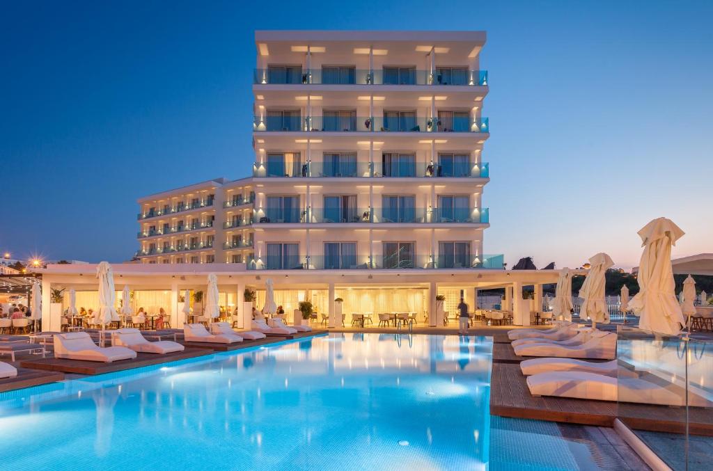 a hotel with a swimming pool and a building at The Blue Ivy Hotel & Suites in Protaras