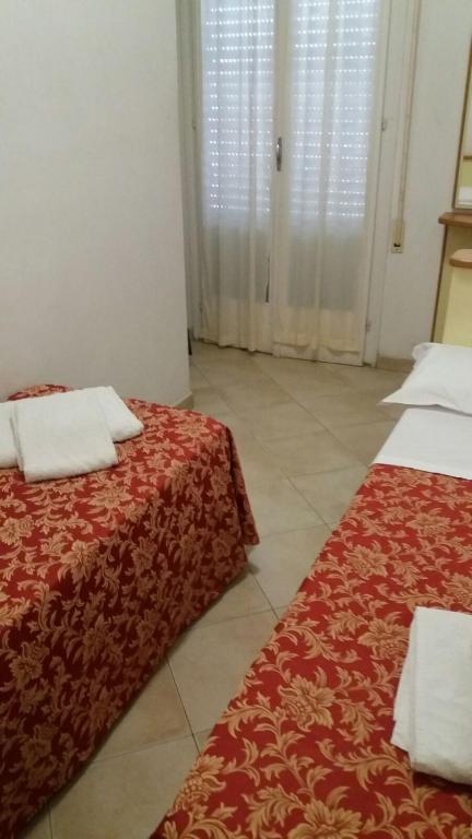 Posteľ alebo postele v izbe v ubytovaní Hotel Nanni Garnì