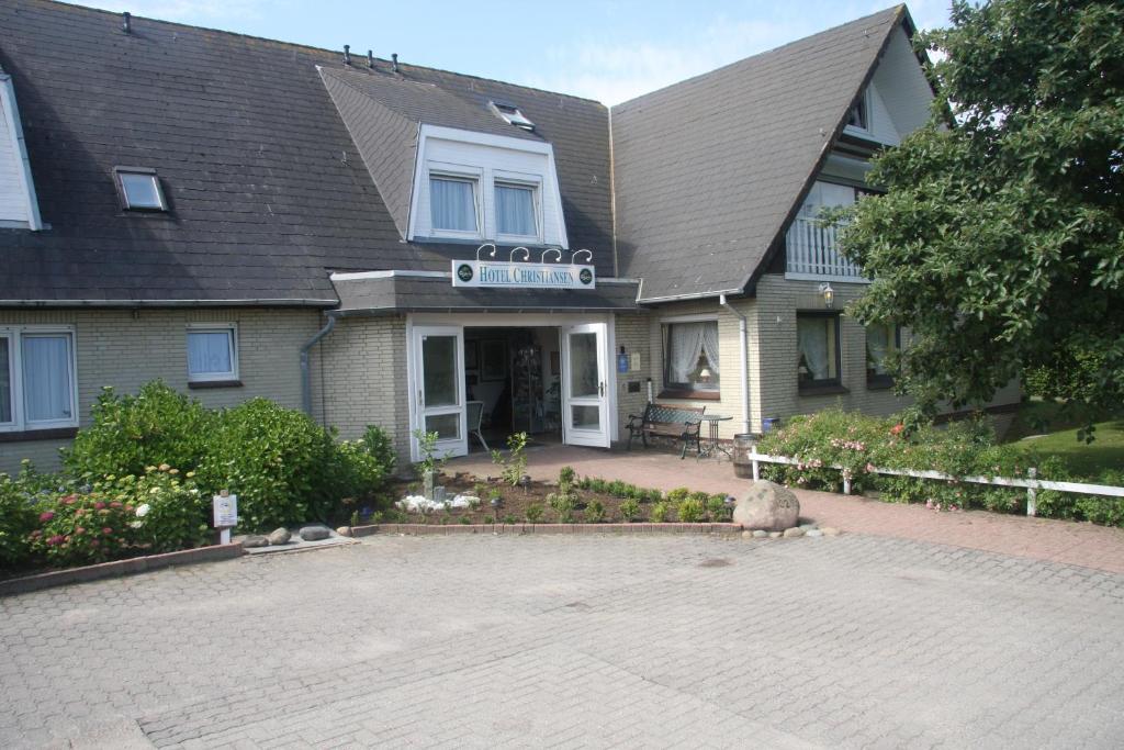 a house with a brick driveway in front of it at Hotel Christiansen in Tinnum