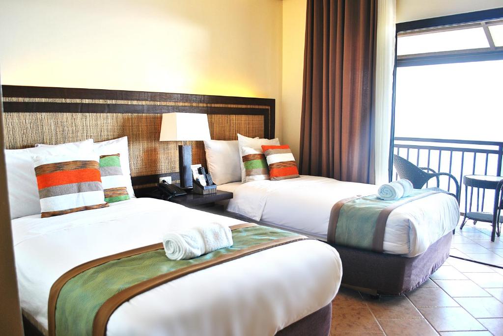 Cama o camas de una habitación en Altamare Dive and Leisure Resort Anilao