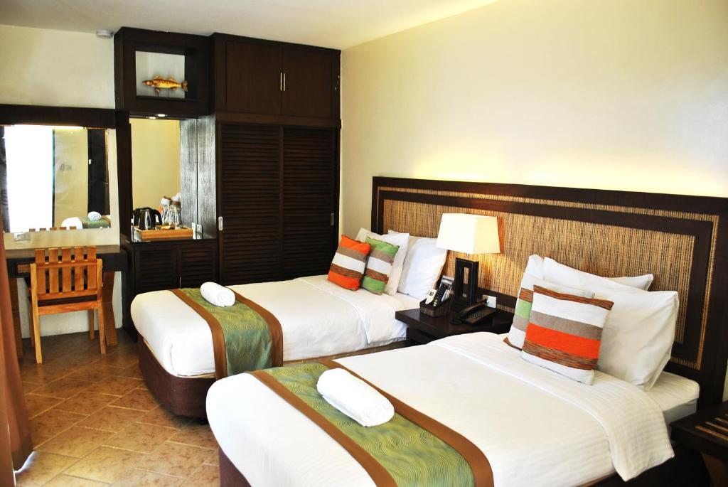 Cama o camas de una habitación en Altamare Dive and Leisure Resort Anilao
