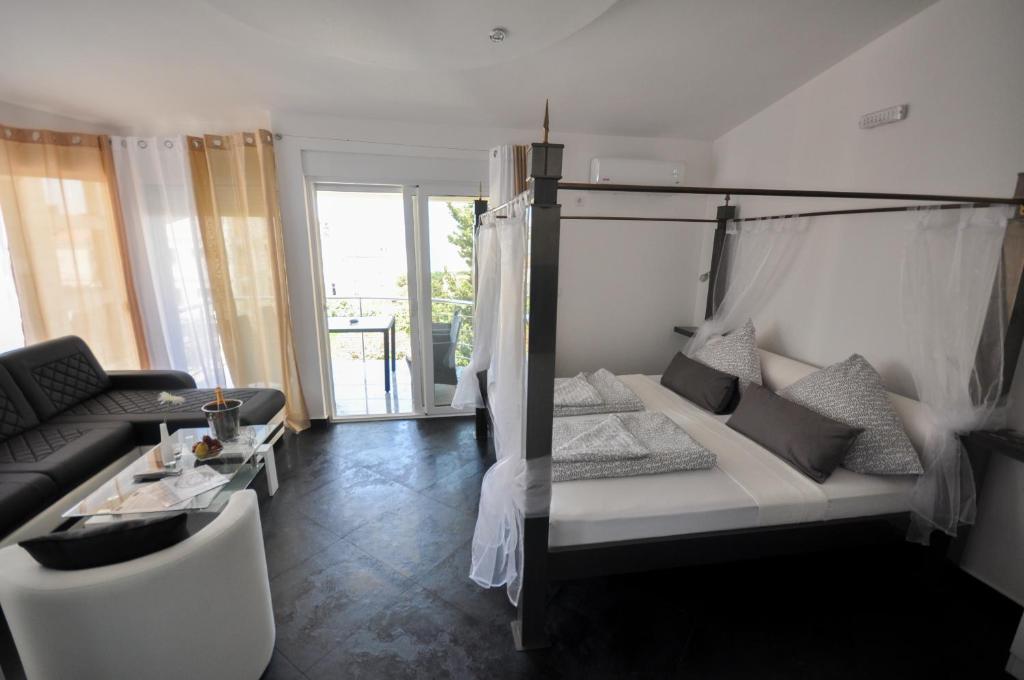 Postel nebo postele na pokoji v ubytování Villa Medusa Apartments