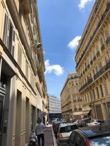 a person walking down a city street with buildings at 10 rue Chevalier Roze in Marseille