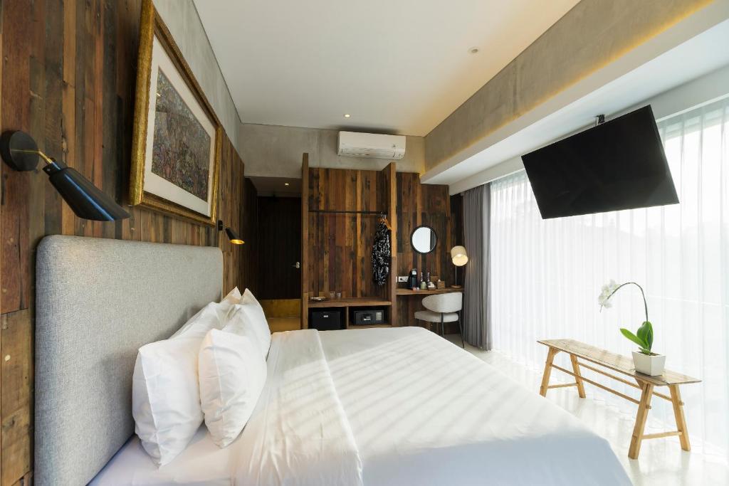 Postel nebo postele na pokoji v ubytování ARTOTEL Haniman Ubud