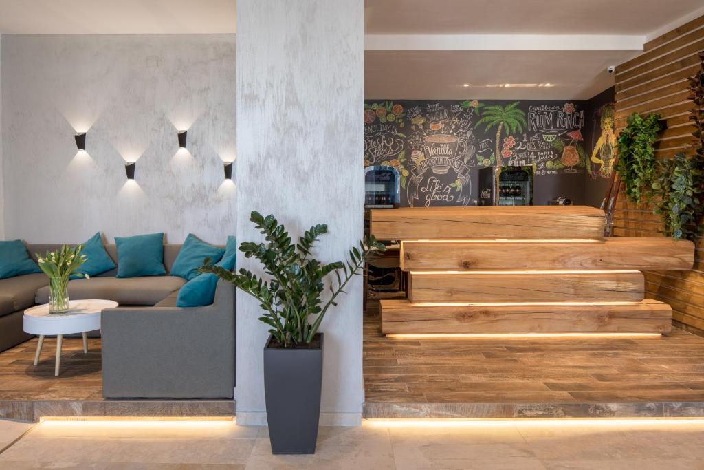 a living room with a staircase and a couch at Hotel Rozmarin in Predeal