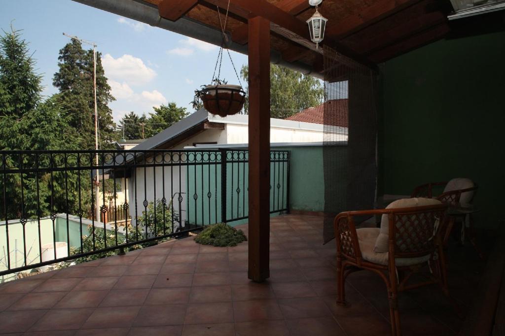 a screened porch with a table and chairs on a balcony at Dalma in Osijek