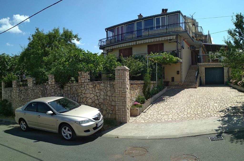 a silver car parked in front of a house at Guest House Julia in Senj