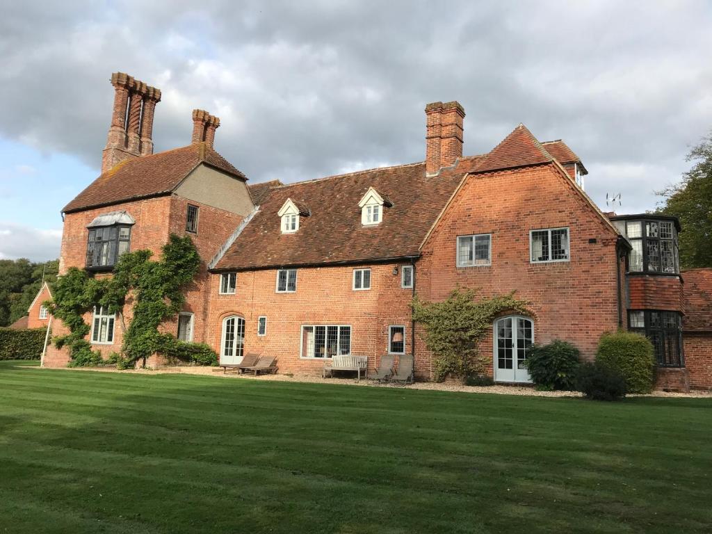 a large brick house with a large grass yard at Borough Court in Hook