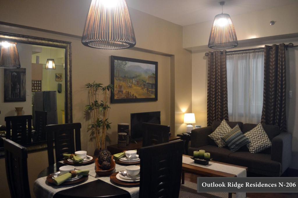a living room with a couch and a table with chairs at Outlook Ridge Residences - North in Baguio
