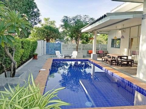 a swimming pool in the backyard of a house at Baan Pare in Pran Buri